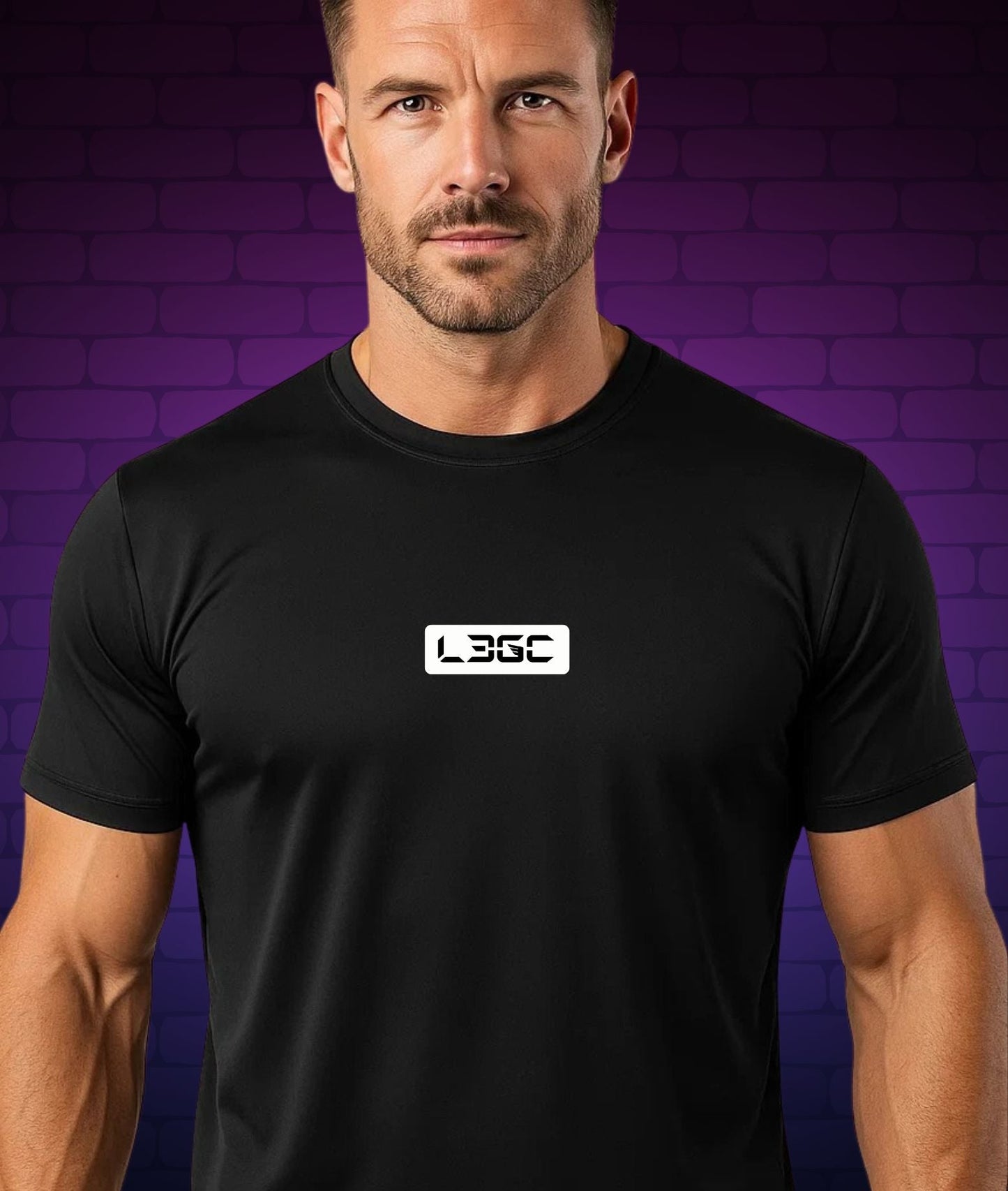 Man wearing a black t-shirt with a logo against a purple brick wall