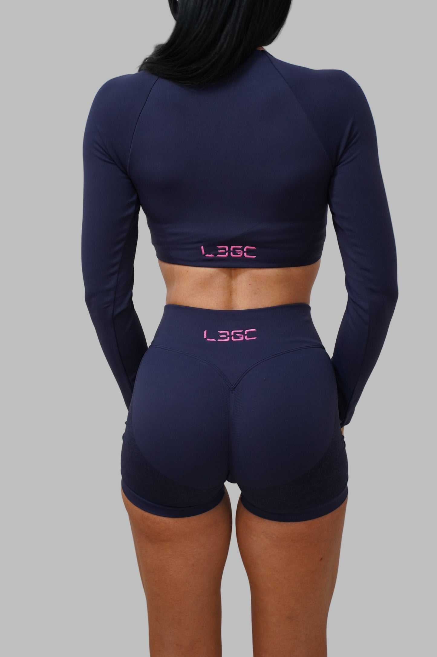 Person wearing navy blue athletic outfit with 'L3GC' branding on a white background