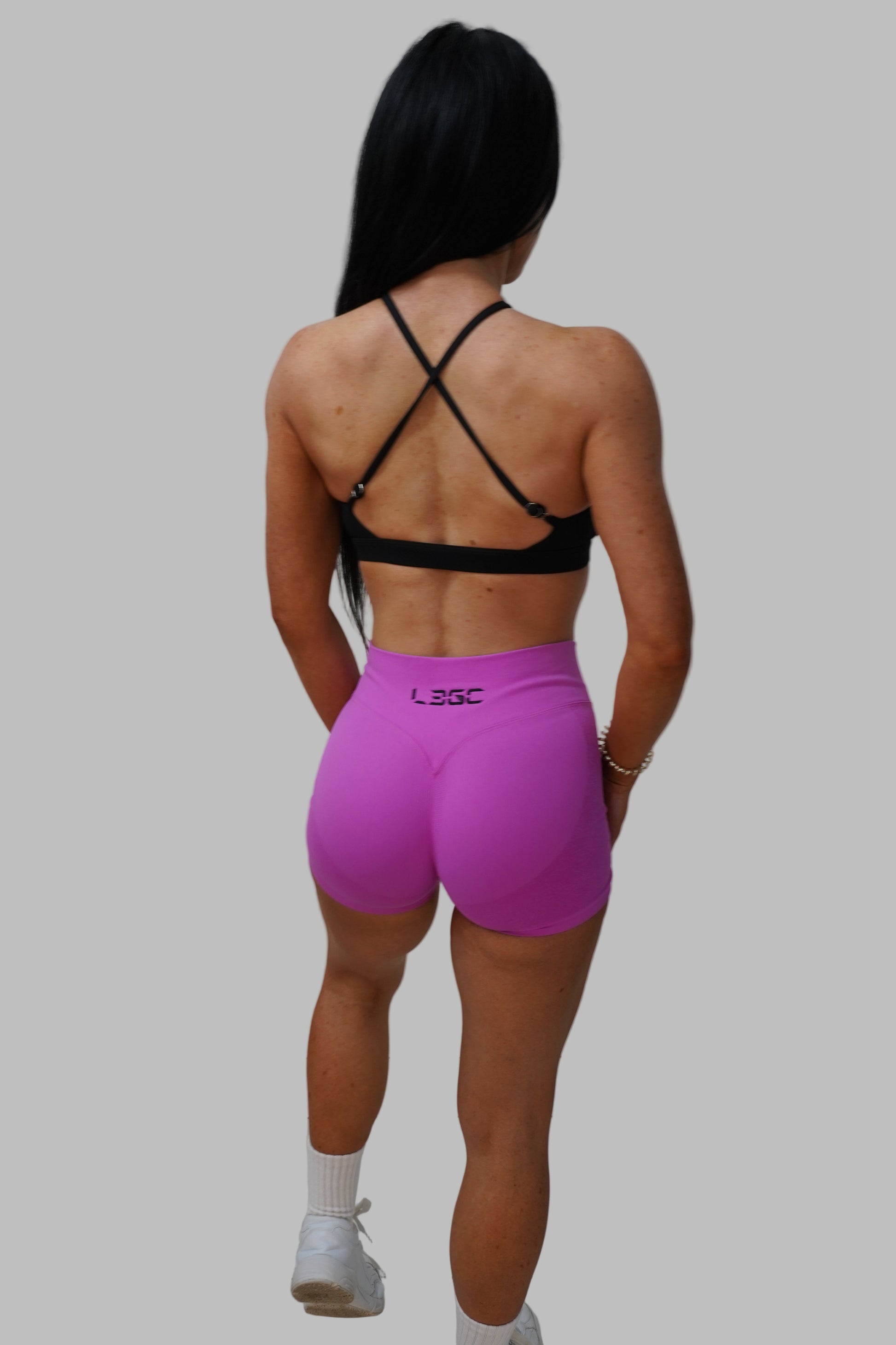 Person in pink shorts and black top.
