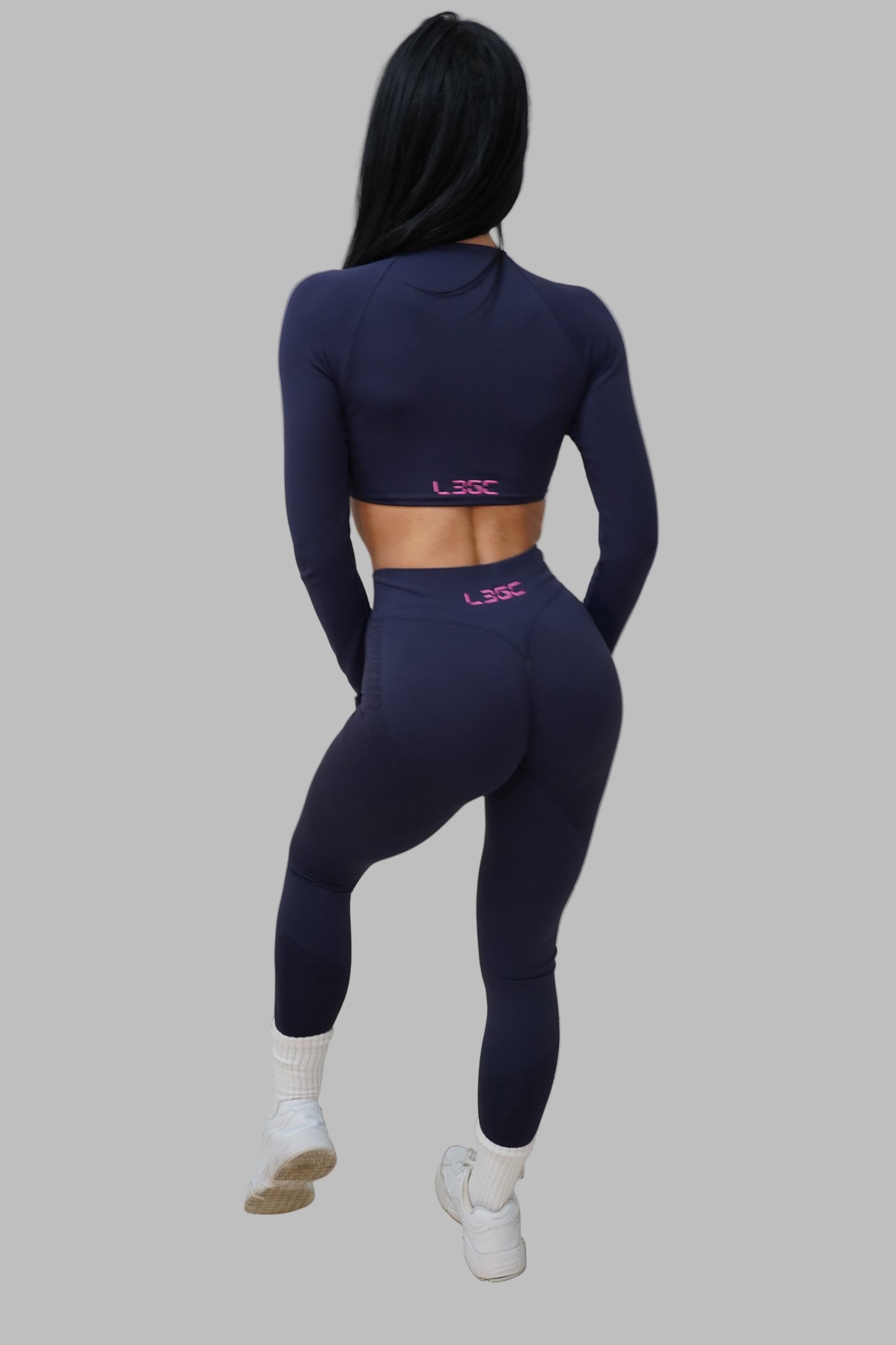 woman wearing navy blue leggings with LEGC logo.